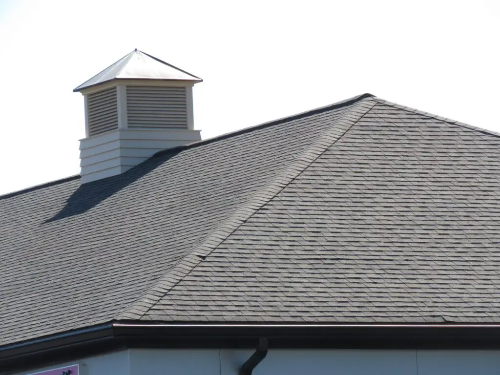 A hip on an asphalt shingle roof.