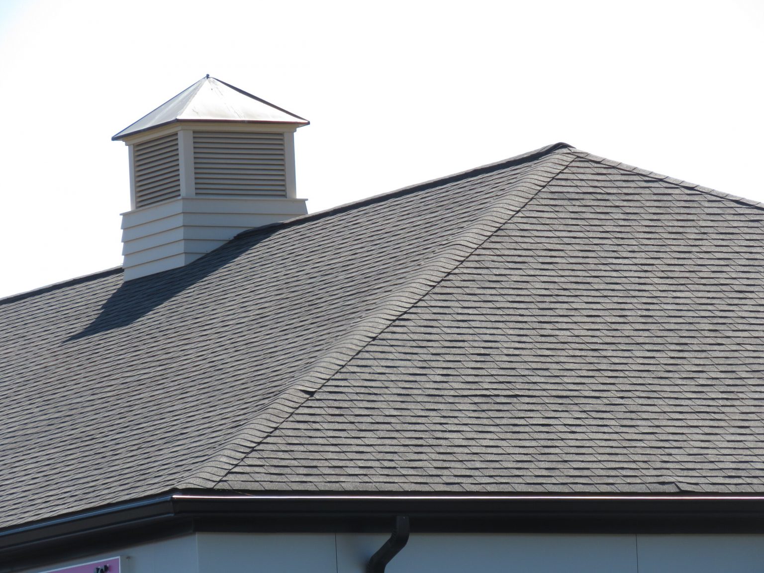 A hip on an asphalt shingle roof.