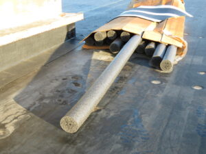 A box of 3-inch closed-cell backer rod lying on an EPDM roof.