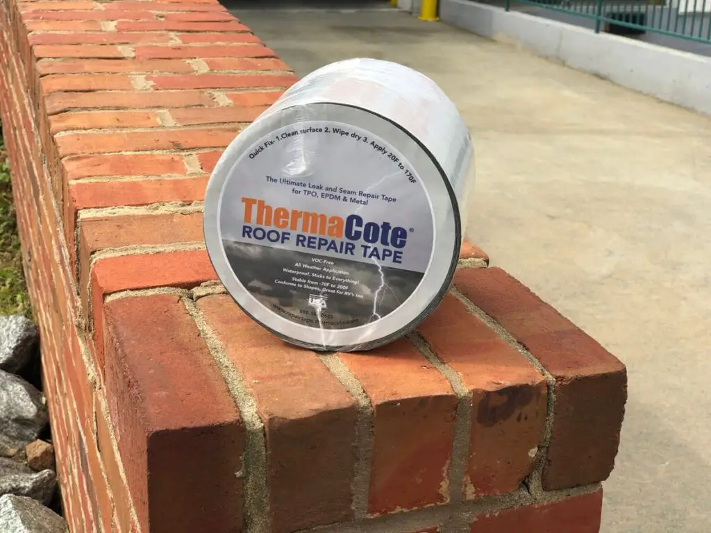 A roll of ThermaCote Roof Repair Tape sitting on a brick wall.