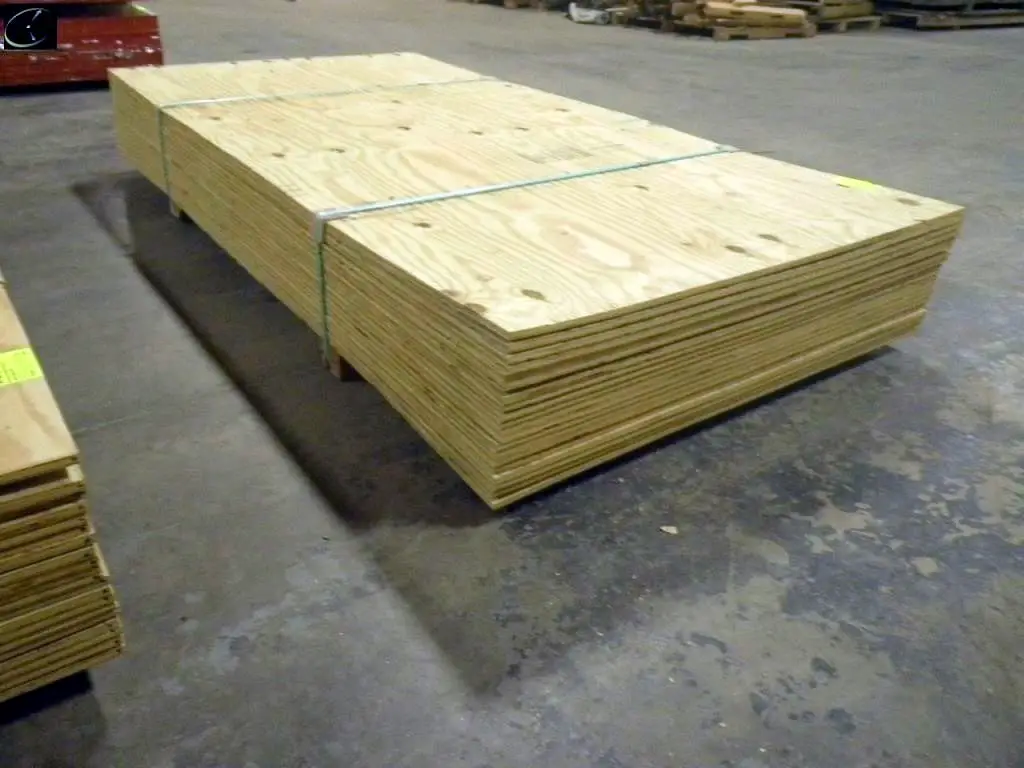 A stack of pressure-treated plywood.