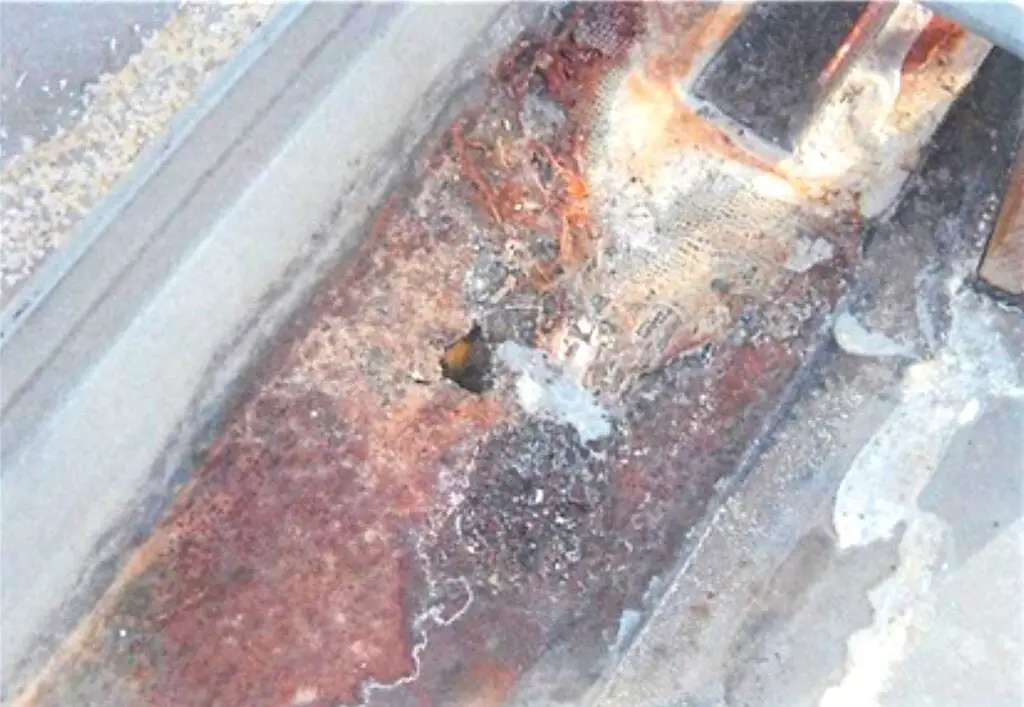 Severe galvanic corrosion on a metal roof panel.