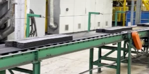 New asphalt shingles coming off a production line in a factory.