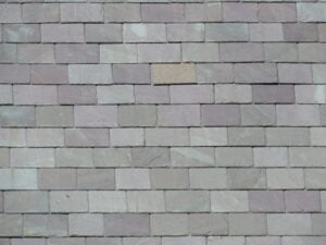 Gray and purple roofing slates installed on a roof.