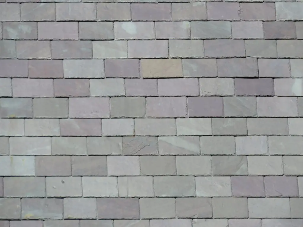 Gray and purple roofing slates installed on a roof.