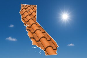Outline of the State of California filled in with an image of a clay tile roof, set against a background of blue sky with clouds and sun.