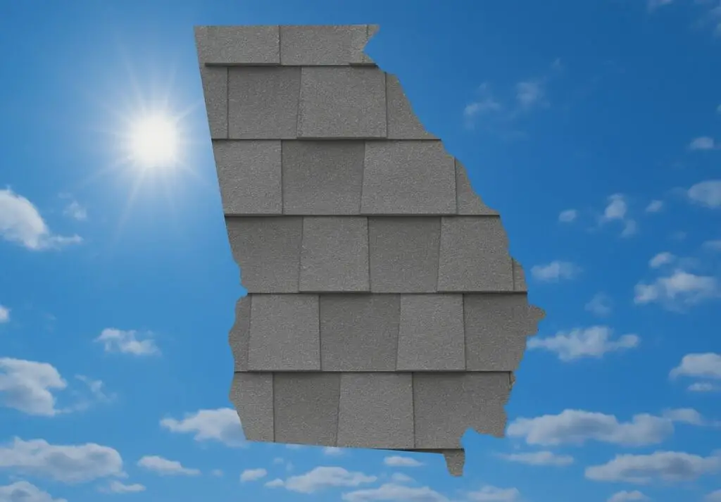 Outline of the State of Georgia filled in with an image of asphalt shingles, set against a background of blue sky with clouds and sun.