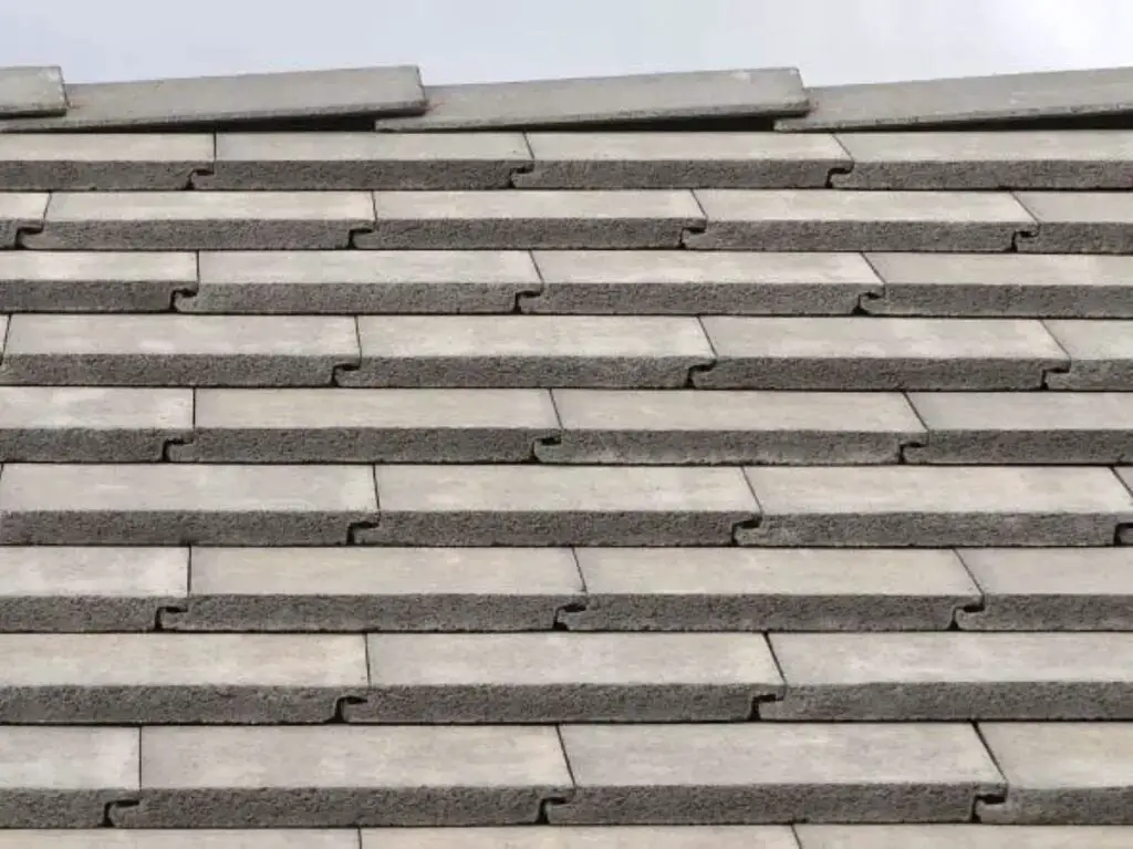 Basic flat concrete roof tiles installed on a roof.