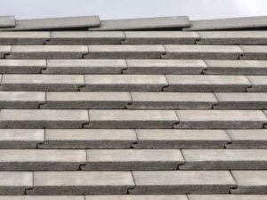 Basic flat concrete roof tiles installed on a roof.